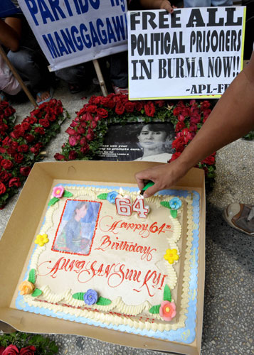 Aung San Suu Kyi 64th: Candles are lit on a birthday cake for Aung San Suu Kyi 64th birthday