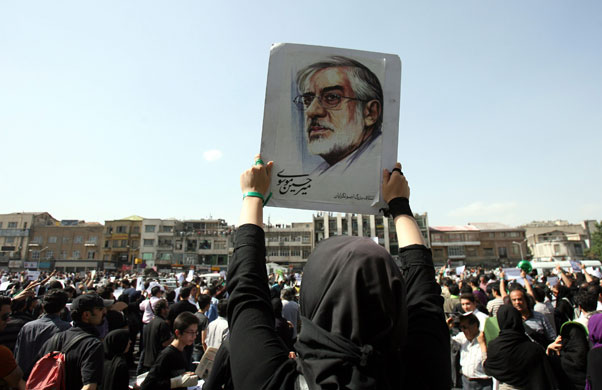 Iran demonstrations: A supporter holds up a poster of Mir Hossein Moussavi in Tehran, Iran