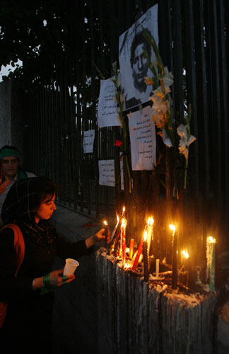 Iran demonstrations: A woman lights a candle for Mehdi Karami, who was killed on Monday June 16