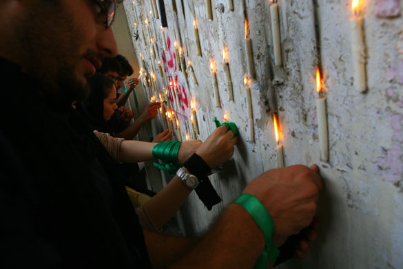 Iran demonstrations: Mousavi supporters attach candles to a wall in Tehran, Iran
