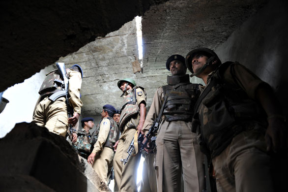 19 June 2009: Srinagar, India: Paramilitary troopers inside a house where a bomb exploded