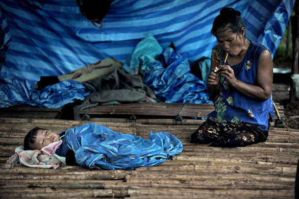 19 June 2009: Thailand: A Karen refugee lights up her pipe