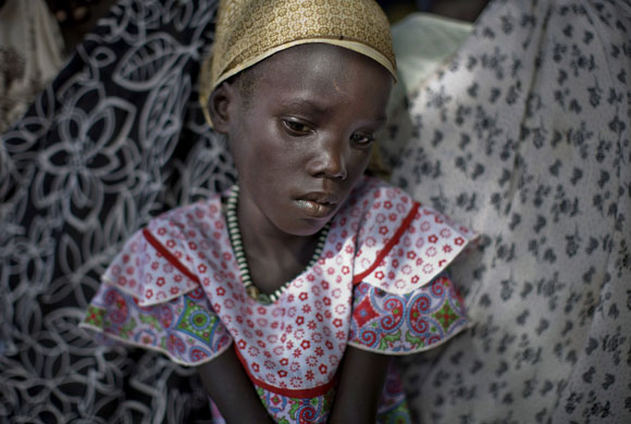 19 June 2009: Nasir, Sudan: A Nuer girl waits to be admitted to a health clinic