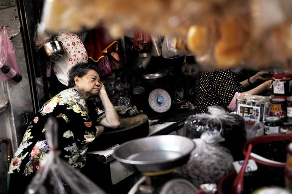 24 hours in pictures: A woman takes a nap in a shop in the Chinatown area in Bangkok