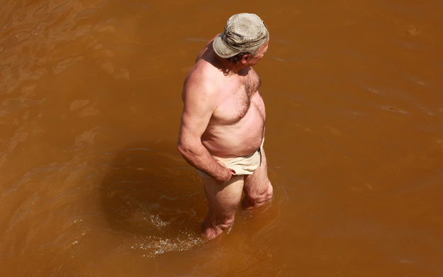 24 hours in pictures: A sun bather enjoys the sea Brighton