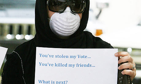 A woman protests against the election results outside the Iranian embassy in Kuwait City