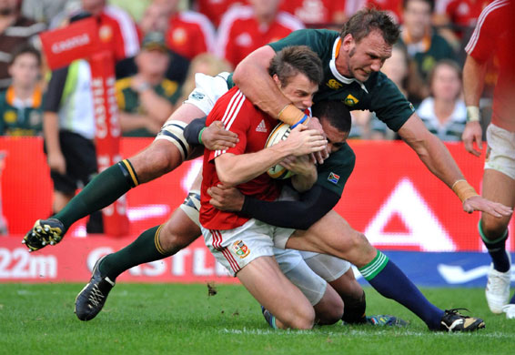 lions 1st test: Tommy Bowe is brought down by Andries Bekker and Bryan Habana 