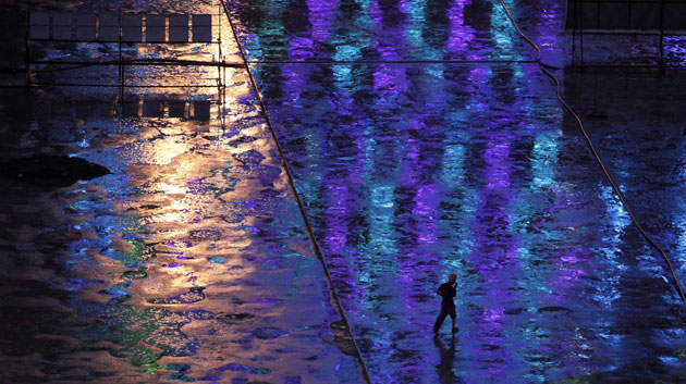 24 hours in pictures: Shanghai, China: A migrant labourer at a construction site after rain 