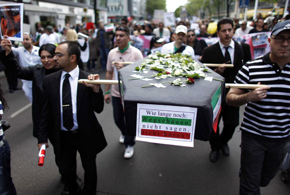 Protests about Iran: Berlin, Germany: Protesters carry a mock coffin and picture of a victim
