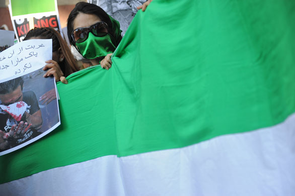 Protests about Iran: Istanbul, Turkey: A masked Mousavi supporter holds a national flag