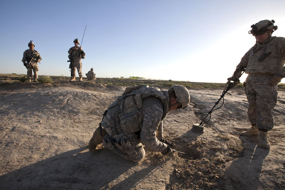 Sean Smith in Afghanistan: American soldiers use a metal detector to search for IEDs