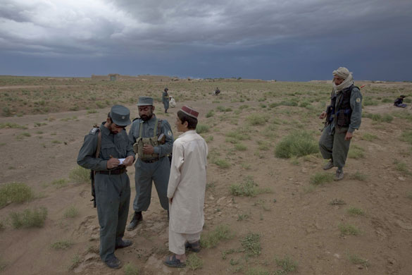 Sean Smith in Afghanistan: Afghan police question bypassers after a vehice was hit by an IED