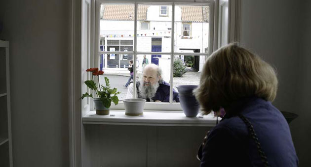 Colin Fenn: Man at gallery window, Pittenweem