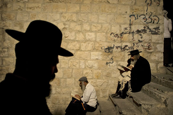 24 hours in pictures: Ultra Orthodox Jewish men pray at Joseph's Tomb in the West Bank