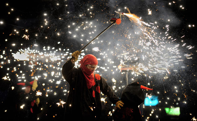 24 hours in pictures: Revellers take part during a traditional festival in Barcelona