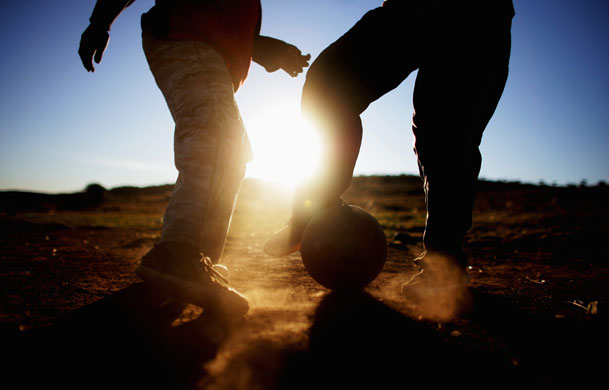 24 hours in pictures: hildren play football in Erasmia township