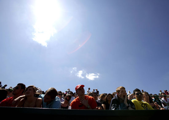 24 hours in pictures: Spectators sit in the sun Tennis Championships at Wimbledon