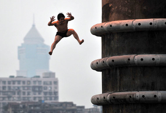 24 hours in pictures: A swimmer jumps into the Han River in Wuhan