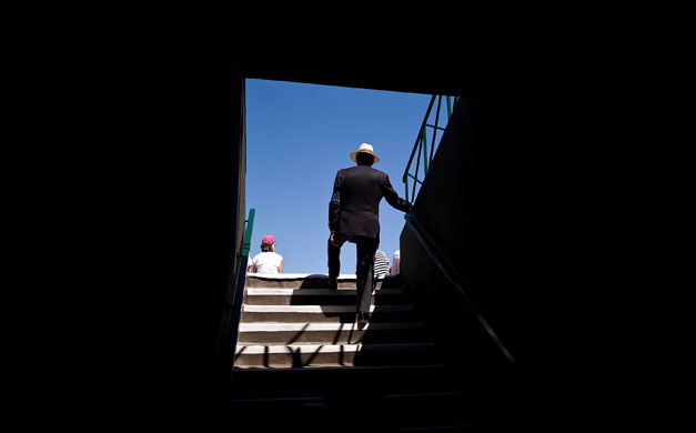 24 hours in pictures: A steward watches the action at Wimbledon Tennis Championships