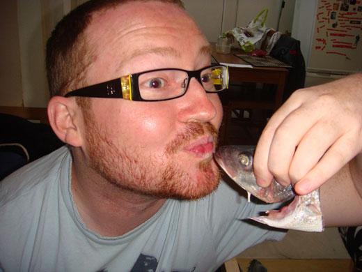 Allegra McEvedy fish: Mike puckers up to a decapitated fish head. Nice