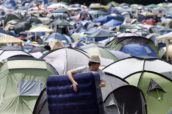 Glastonbury arrivals: A camper drags an inflatable mattress at the Glastonbury festival