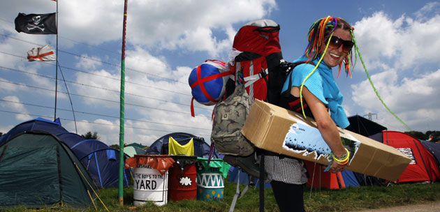 Glastonbury arrivals: A festival goer arrives at the Glastonbury festival 