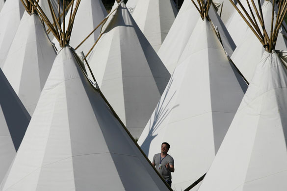 Glastonbury day two: A man looks at one of the tipi tents at the Glastonbury Festival 2009
