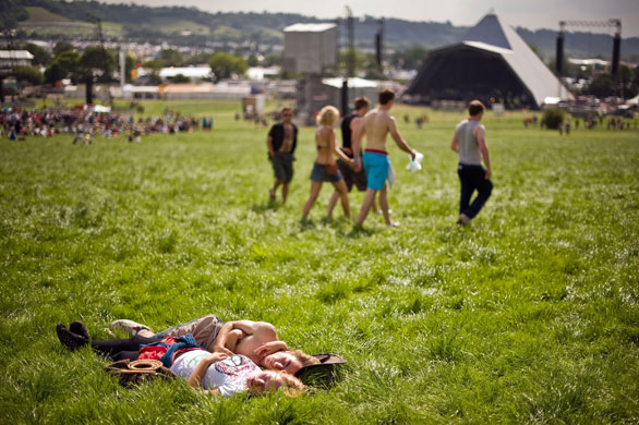 Glastonbury day two: A couple relax in the sun at the Glastonbury festival 2009