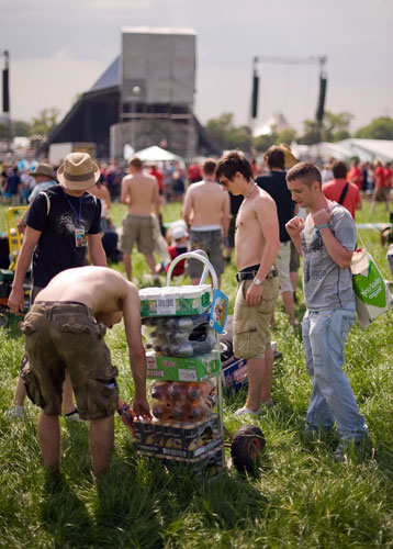 Glastonbury day two: Festivalgoers arrive with their stock of beer at Glastonbury festival 2009