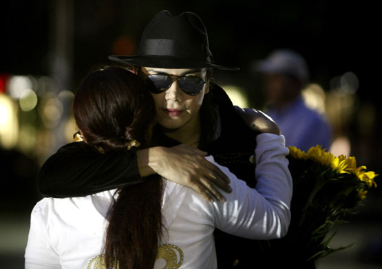 Jackson lookalikes: Fans of Michael Jackson embrace each other during a vigil in Mexico City