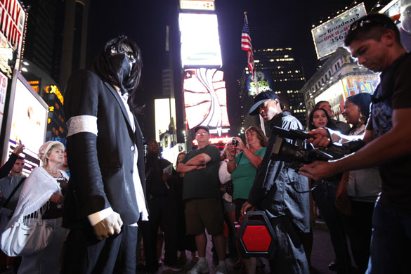 Jackson lookalikes: A Michael Jackson impersonator poses for pictures in Times Square
