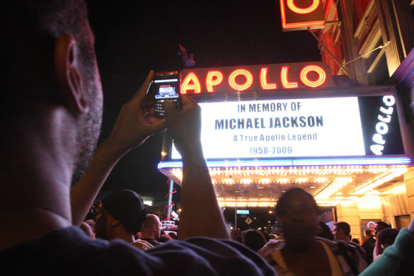 Michael Jackson reaction: Tshaka Lafayette takes a picture of the marquee at the Apollo theatre