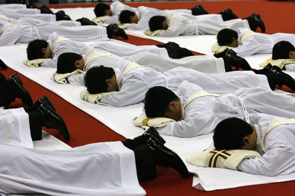 26 June 2009: Seoul, South Korea: New priests prostrate themselves before the altar