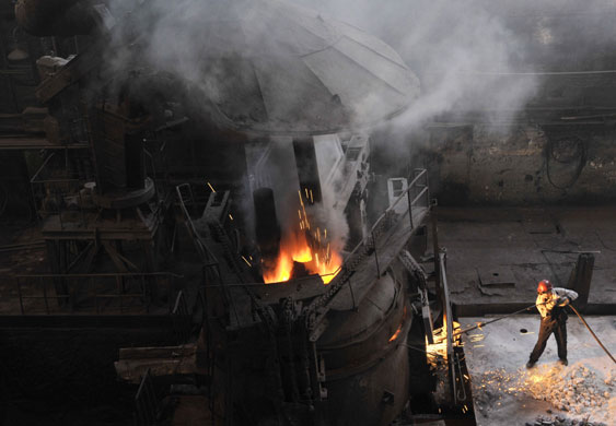 26 June 2009: Shenyang, China: A labourer works at a steel plant