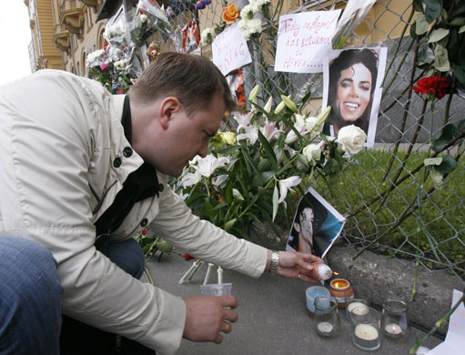 Michael Jackson reactions: A fan puts a candle at the portrait of a pop star Michael Jackson in Moscow