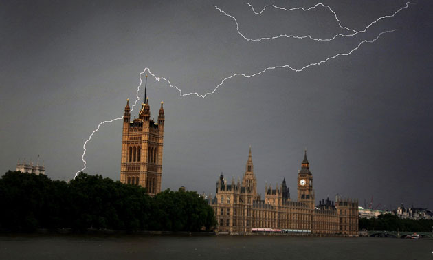 Storm clouds gather and lightning strikes over the Houses of Parliament during a break in the hot weather