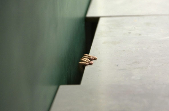 3 June 2009: Jerusalem, Israel: A boy takes cover under a desk in a bomb shelter