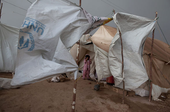 3 June 2009: Jalozai Camp, Pakistan: A girl stands next to her ten