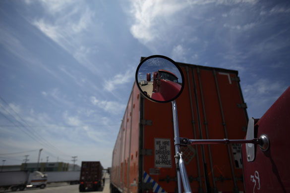 3 June 2009: Tijuana, Mexico: Trucks drive next to the US-Mexico border fence