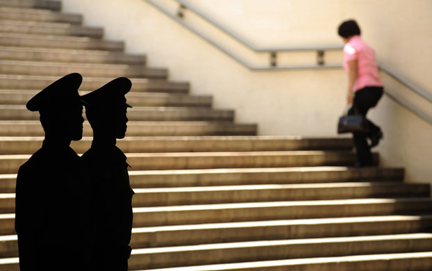 3 June 2009: Paramilitary policemen watch one of the entrances to Tiananmen Square