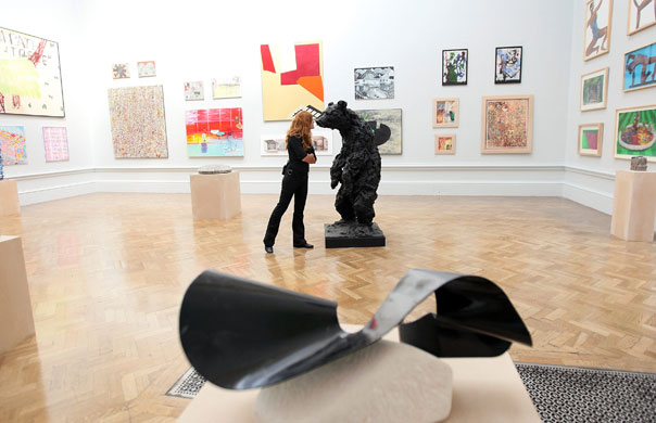 RA Summer Exhibition 2009: A gallery employee looks at a sculpture in the RA Summer Exhibition