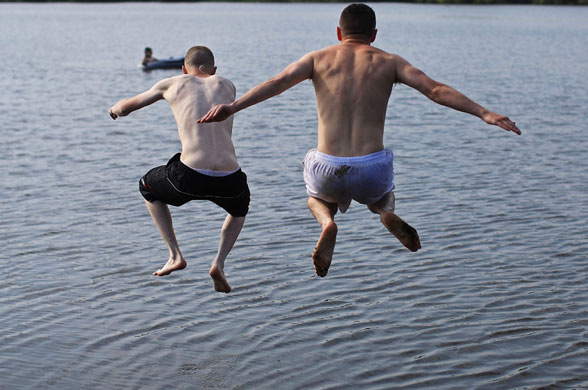 UK weather update: Youths swim in Pickmere Lake to cool off as temperatures soar
