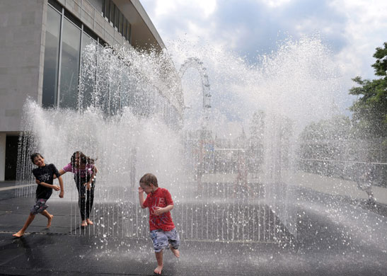 UK weather update:  Children enjoy the weather in the Royal Festival Hall's fountain