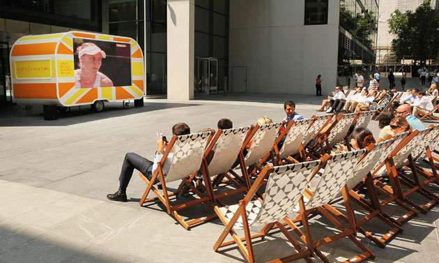 UK weather update: City workers watch Wimbledon tennis on a television mounted in a caravan