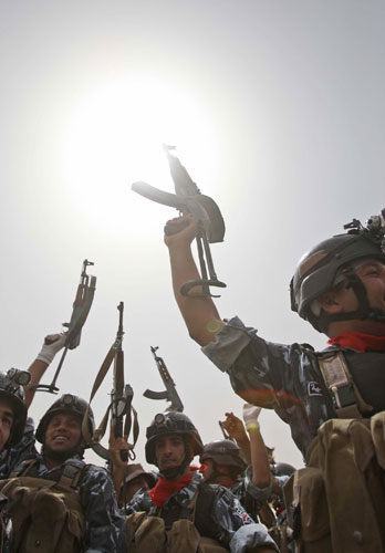 Iraq: Soldiers celebrate following a parade to mark the withdrawal of US troops