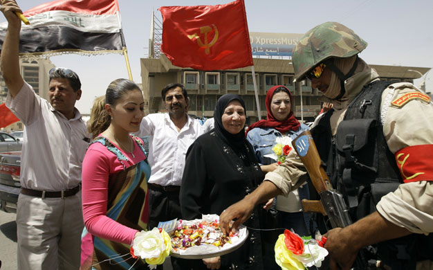 Iraq: Soldiers celebrate following a parade to mark the withdrawal of US troops