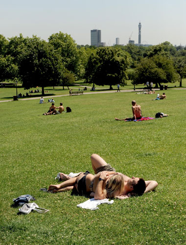 Heatwave: Sunbathers enjoy the sunshine on Primrose Hill, London