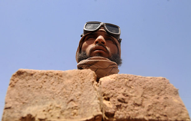 24 hours in pictures: An Afghan day labourer unloads bricks from a kiln Kabul