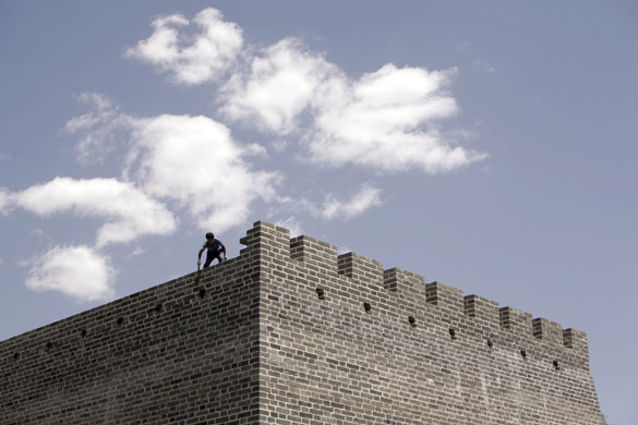 24 hours in pictures: A worker cleans a section of destroyed wall Dynasty City Wall Relics Park