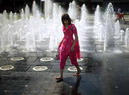 24 hours in pictures: A student cools off in the fountains of Piccadilly Gardens 